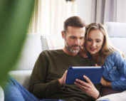 couple reviewing finances on tablet